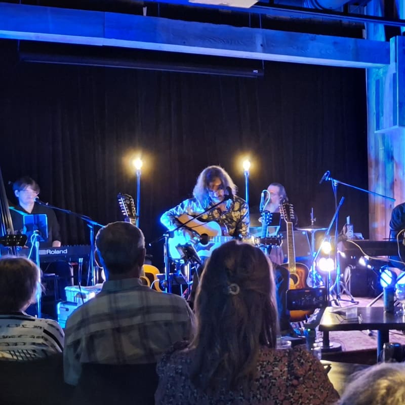 A group of musicians performing in an intimate venue. 